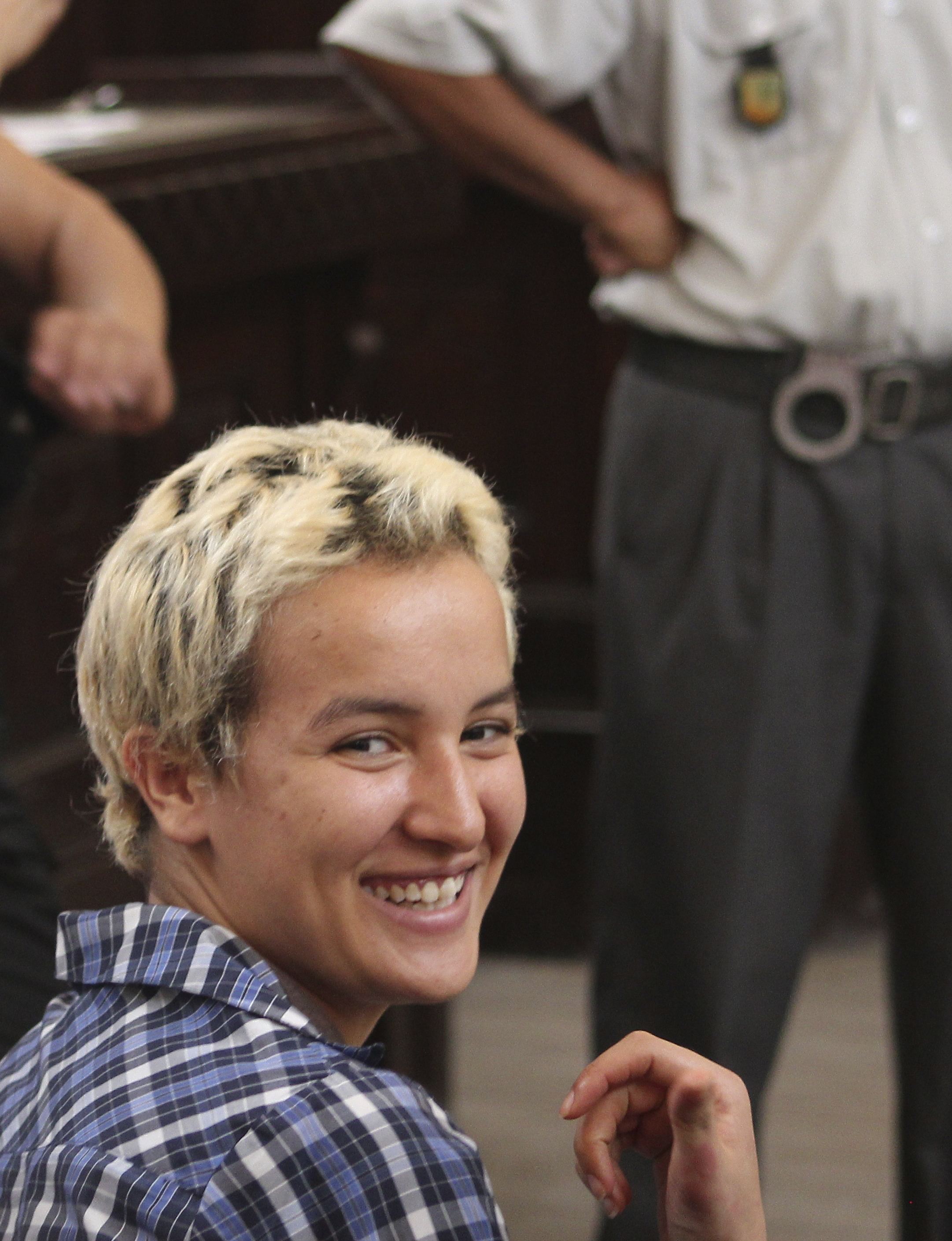 Amina Sboui, the Tunisian member of the Ukrainian feminist group Femen, smiles in a courtroom in Sousse