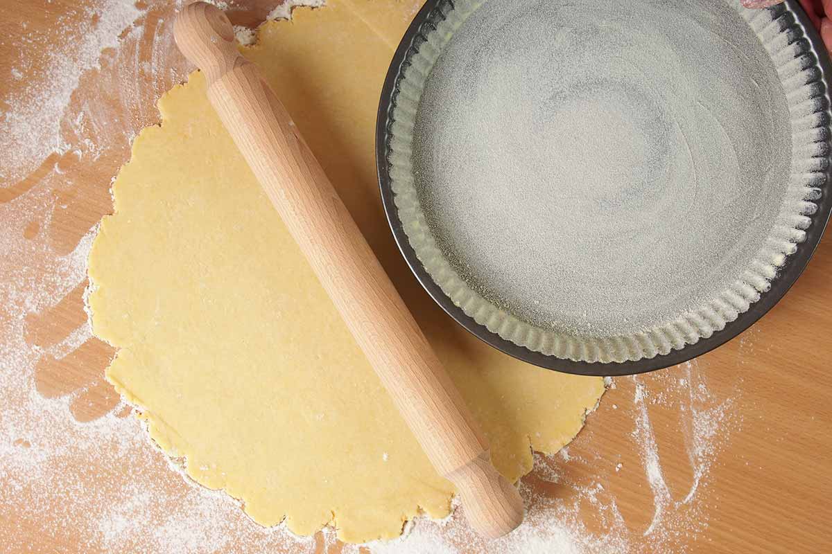 Spianatoia con impasto della pasta frolla, mattarello e teglia rotonda