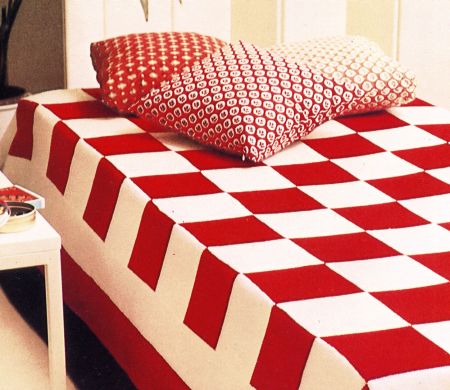 Lavori a maglia: una coperta a scacchiera bianca e rossa