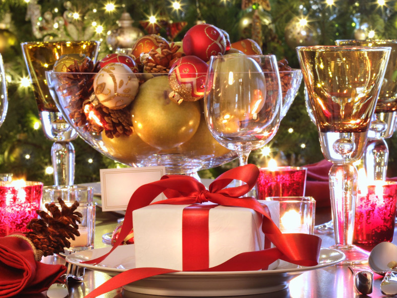 Elegant holiday table setting with red ribboned gift