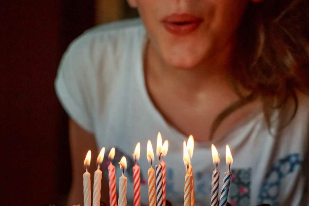 donna spegne candeline sulla torta