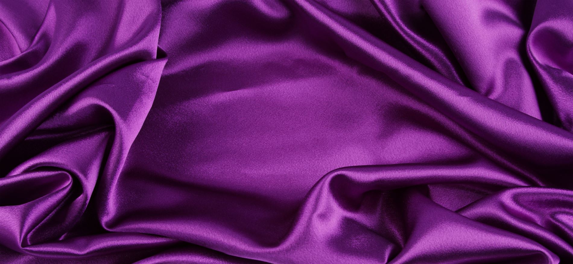 Closeup of purple silk fabric on white background