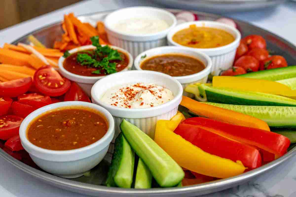 vassoio con verdure in pinzimonio e ciotole con salsine