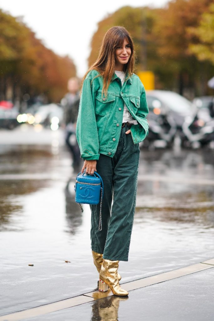 Gala Gonzalez wears a green denim jacket, a white top, green pants, golden boots, a blue Chanel bag, outside Chanel, during Paris Fashion Week - Womenswear Spring Summer 2020, on October 01, 2019 in Paris, France.