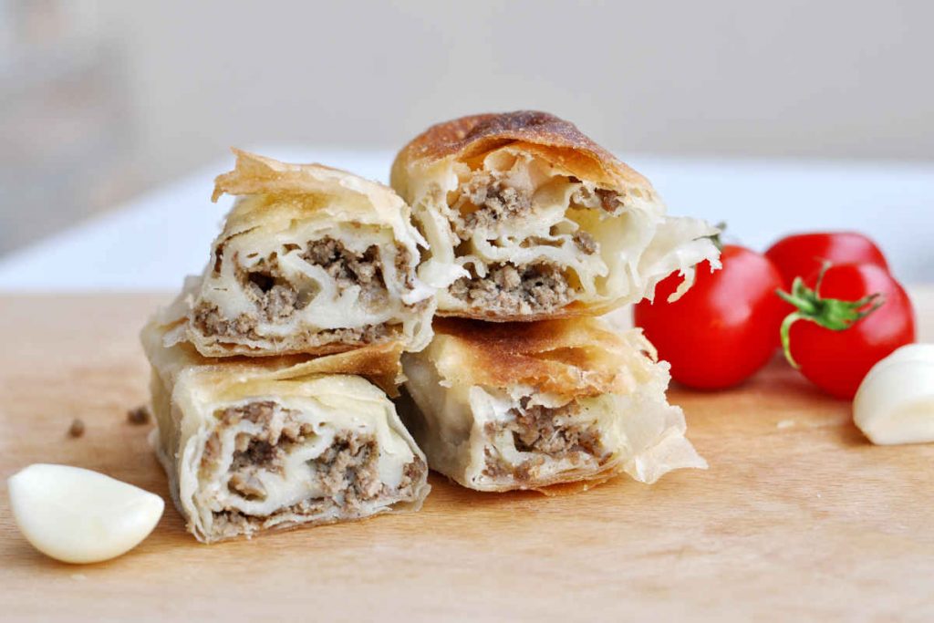 porzioni di strudel salato su tagliere di legno