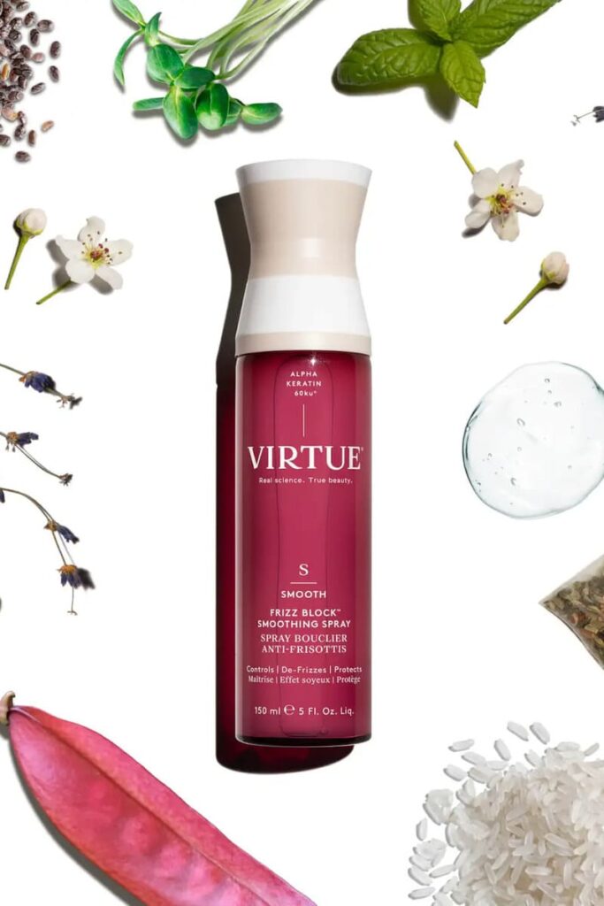 Spray frizz block smoothing di VIRTUE su sfondo bianco con fiori