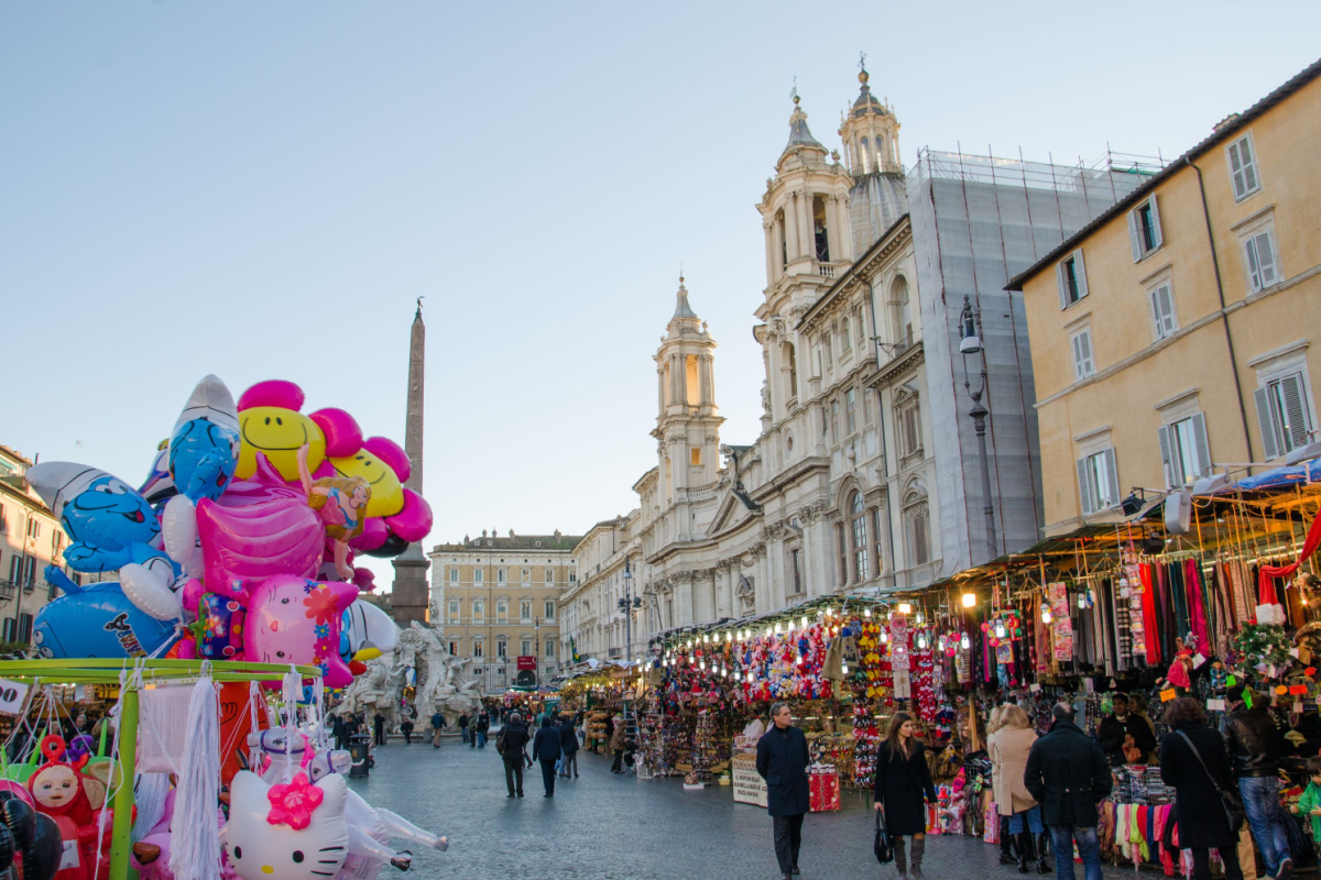 piazza di Roma allestita con mercatini natalizi e palloncini per bambini