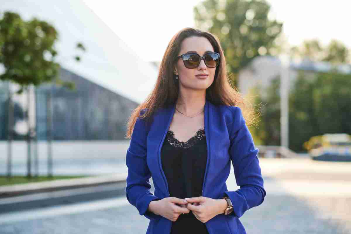 Ragazza con blazer blu e occhiali da sole