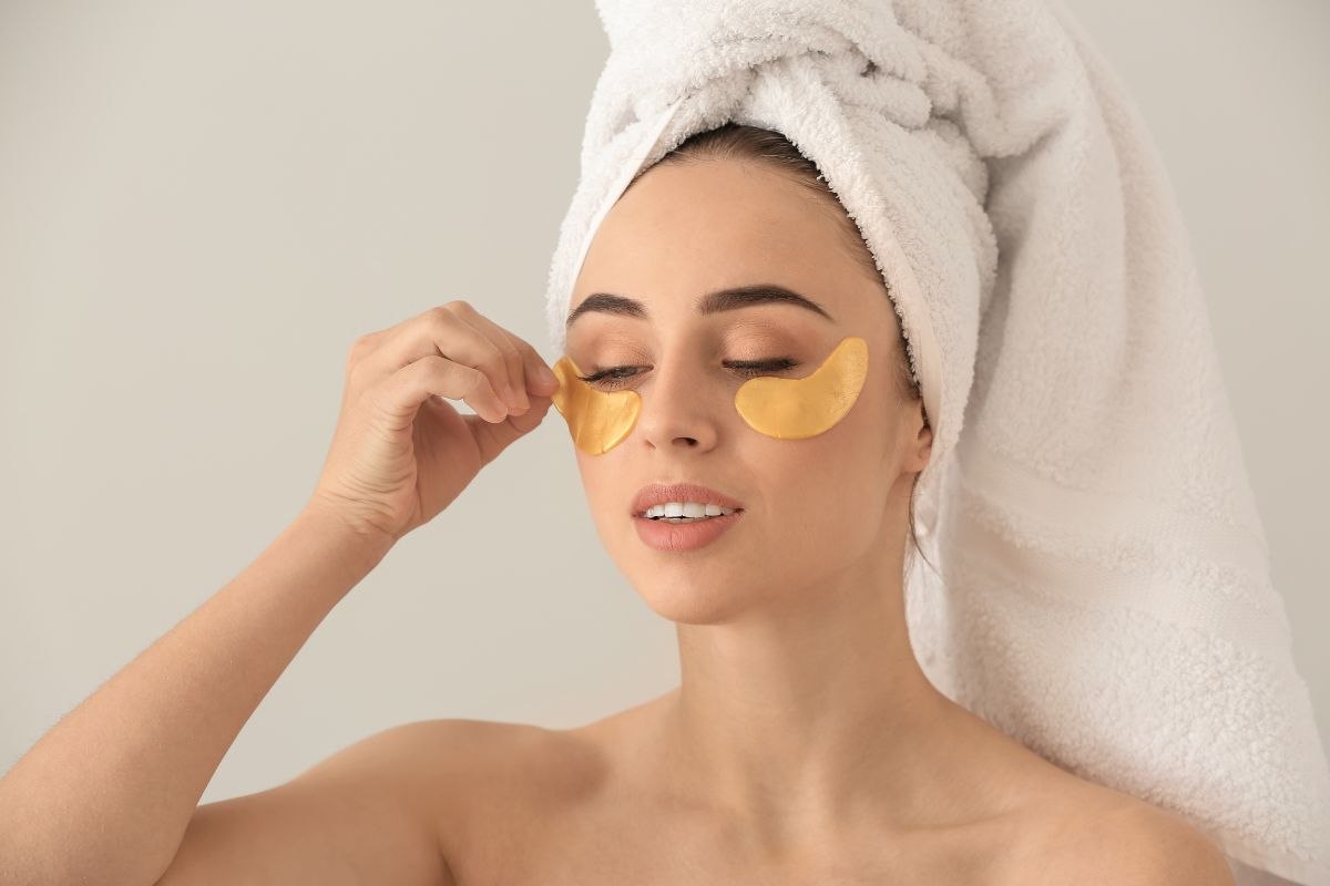 ragazza che applica patch occhi con turbante in testa