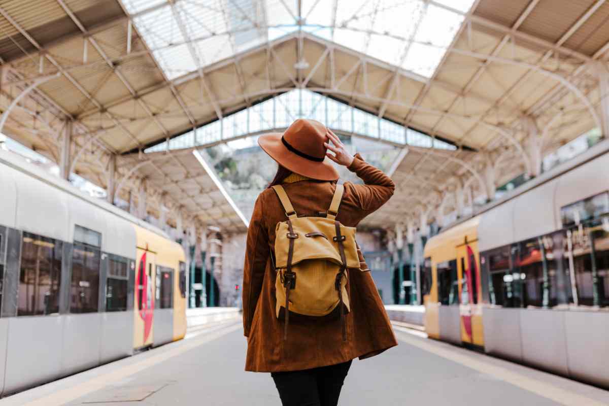 giovane ragazza di spalle in una stazione ferroviaria