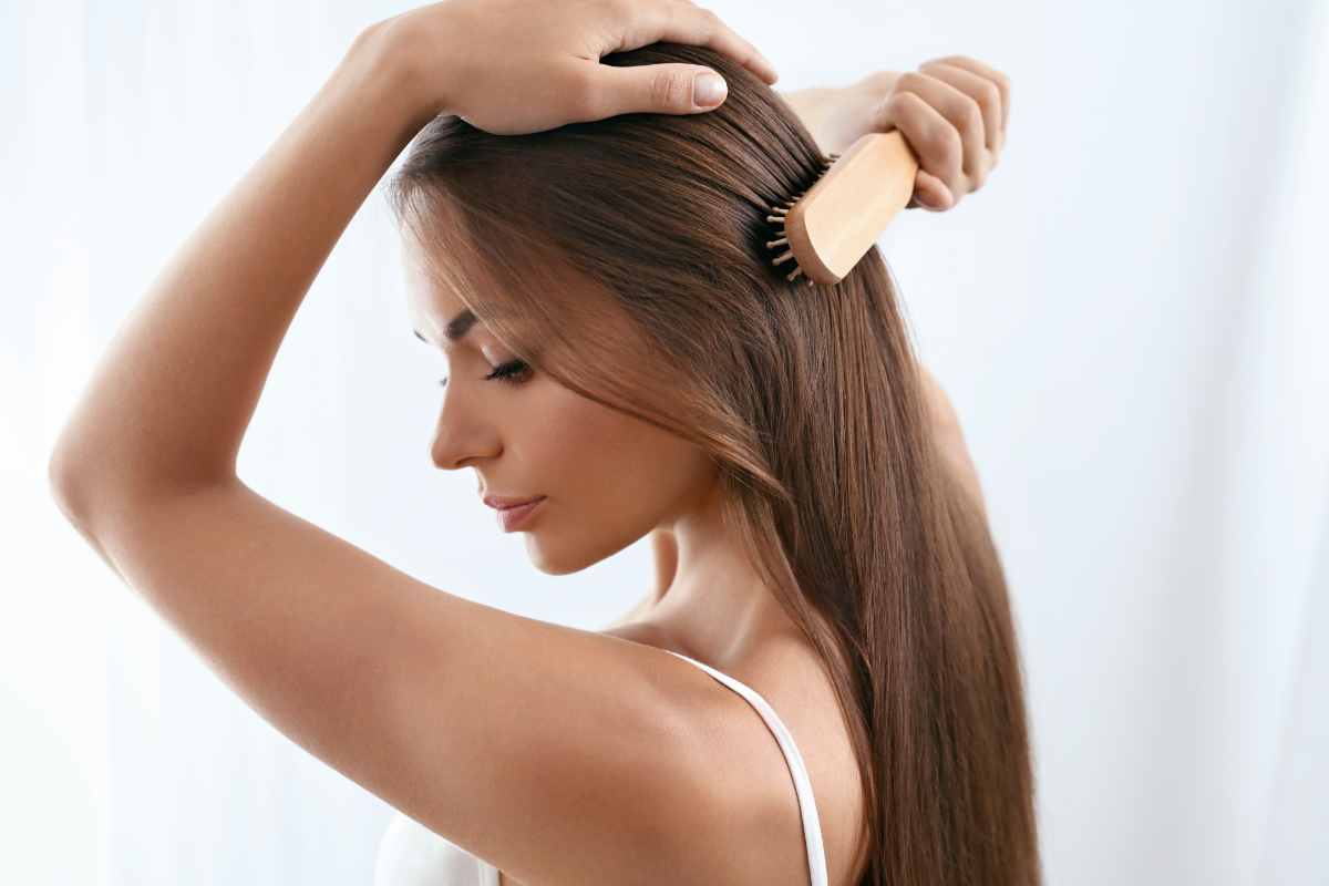 ragazza si spazzola i capelli