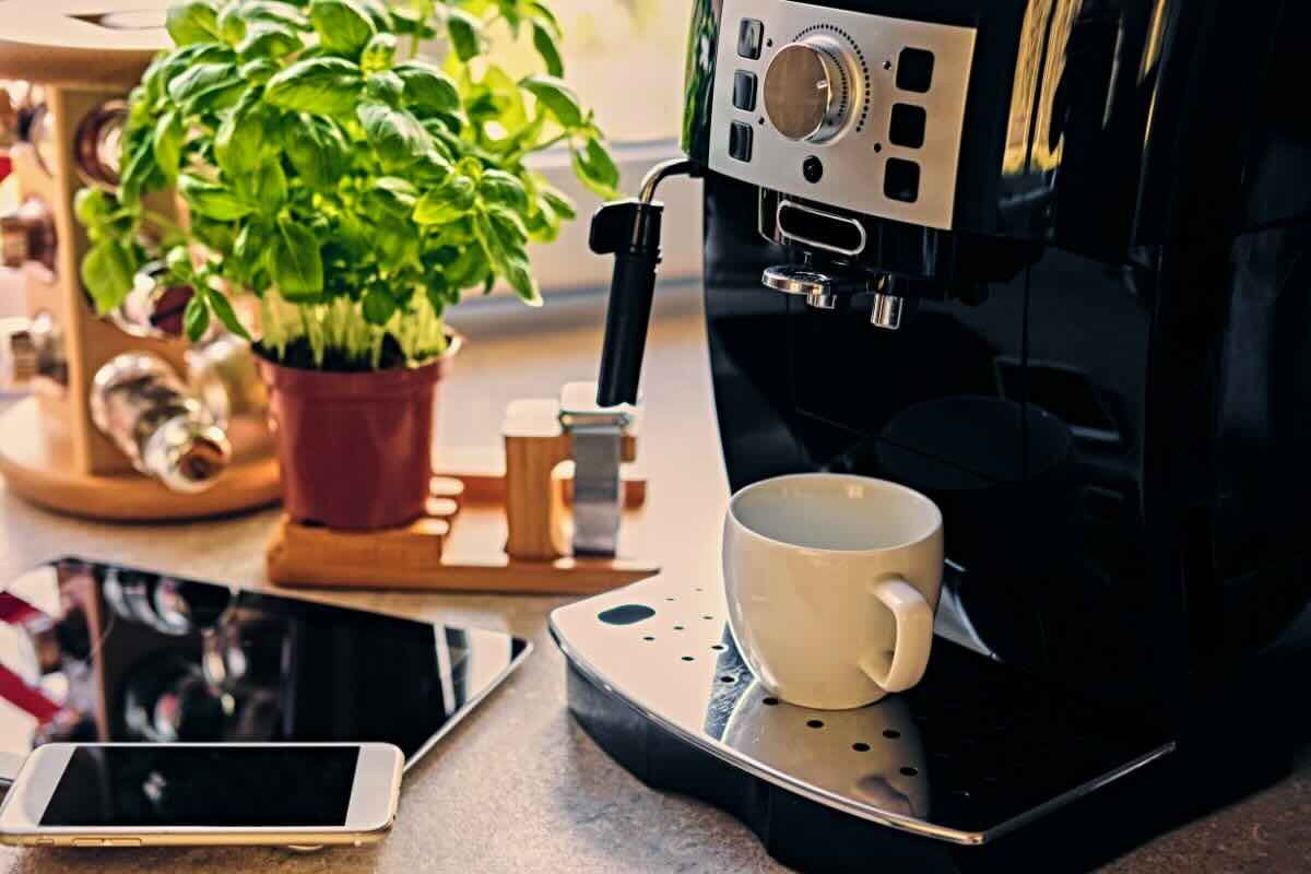 Macchinetta del caffè, tazzina, piantina, smartphone