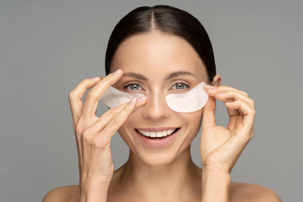 Donna che applica il patch al viso