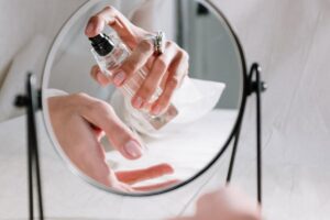 Donna che si spruzza il profumo sul polso