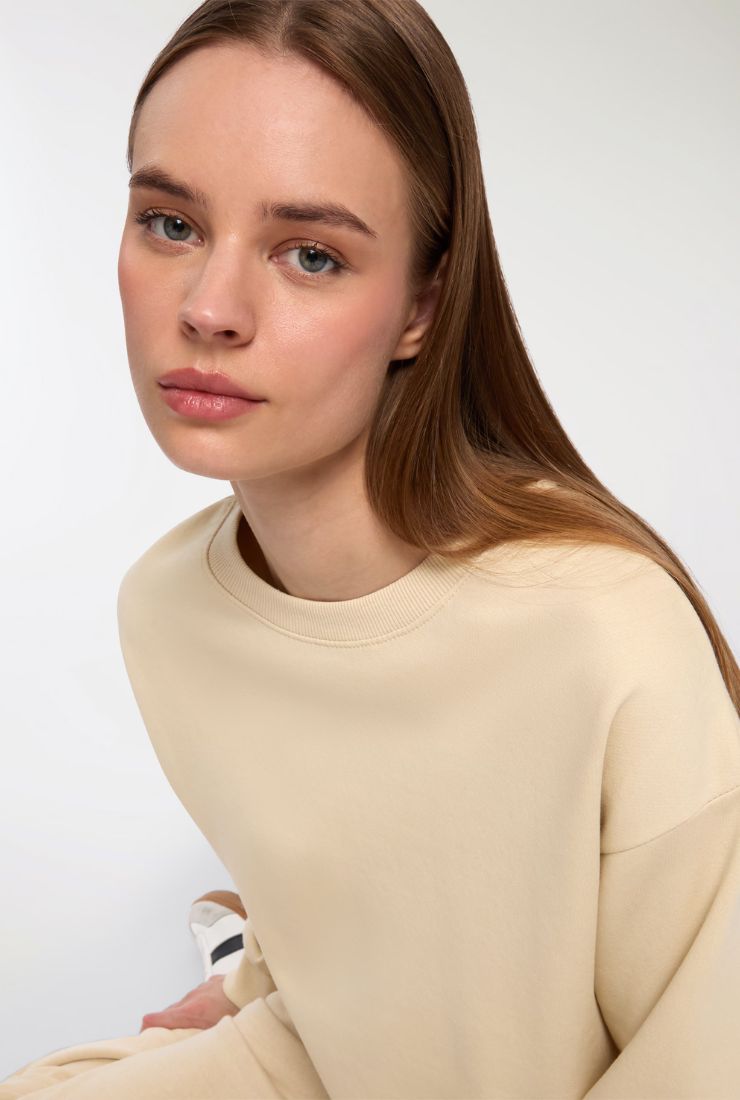 Donna con felpa color crema