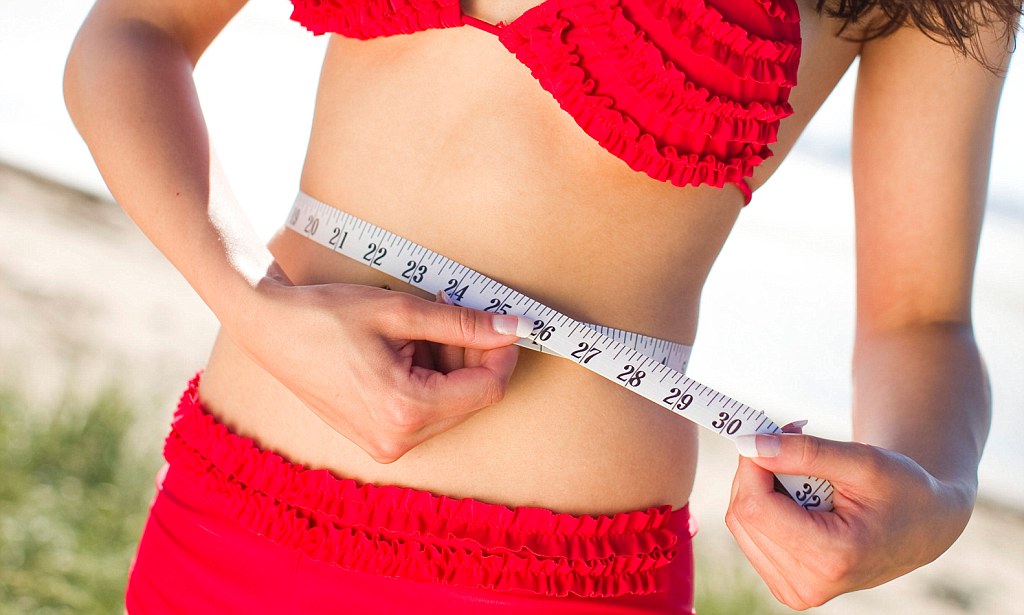 Girl measuring waist