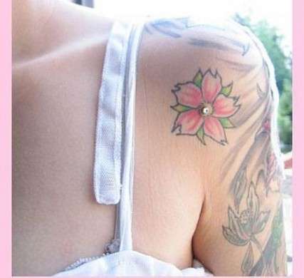 Tatuaggio con fiore e piercing