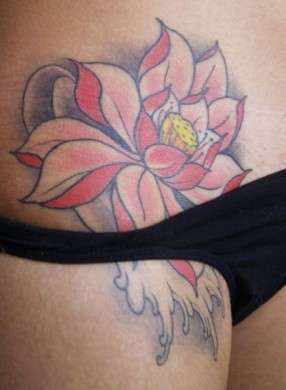 Tatuaggio sull'inguine con fiore colorato
