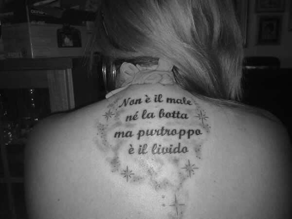 Tattoo sulla schiena con frase di canzone
