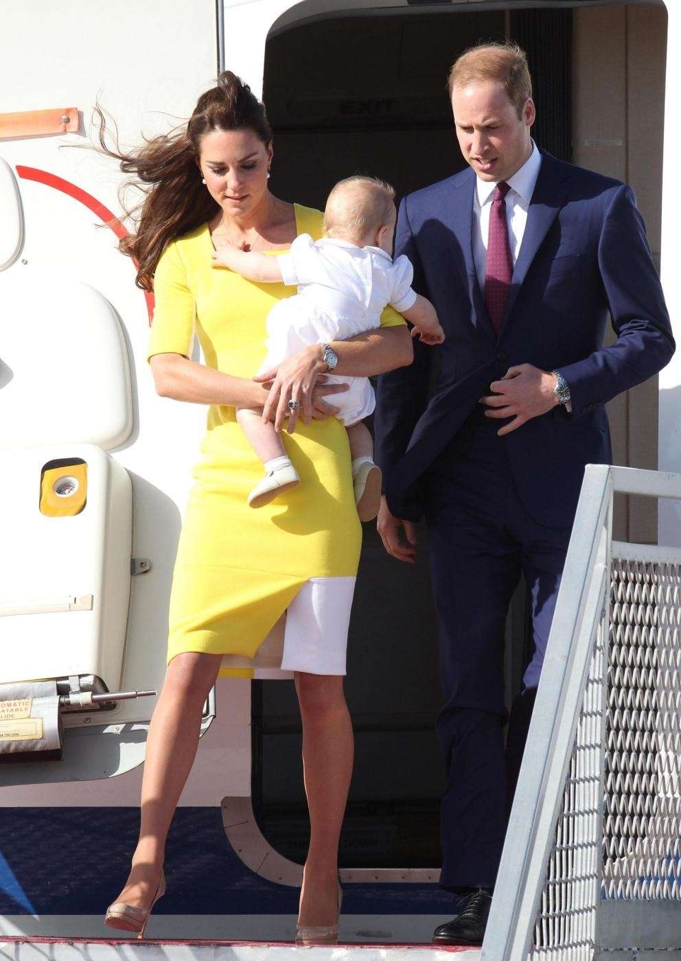 Il principe William e Kate Middleton con George in aeroporto
