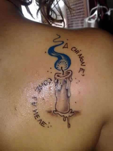 Tatuaggio frase di Tiziano Ferro con candela