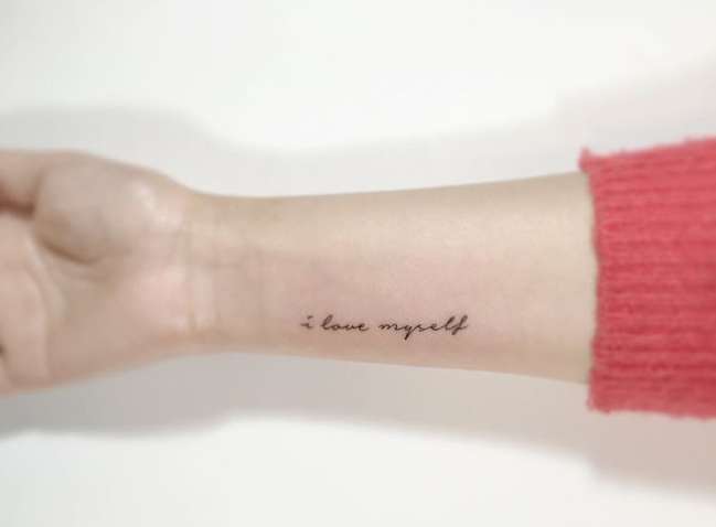 Tatuaggio con breve frase in inglese sull'autostima